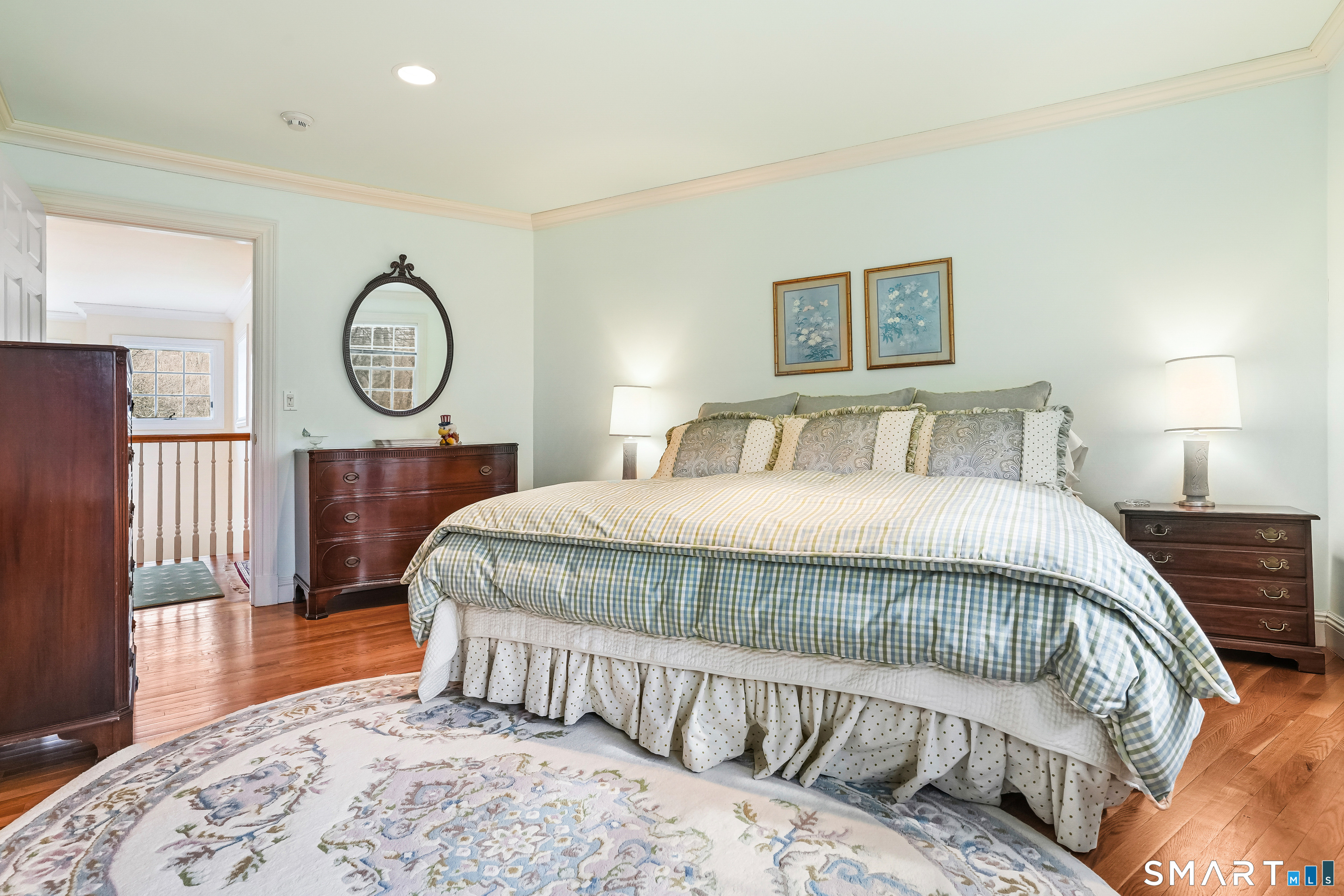 41 Lake Wind Road New Canaan, CT 06840 - Photo 20 of 38 a bedroom with a large bed and a chandelier