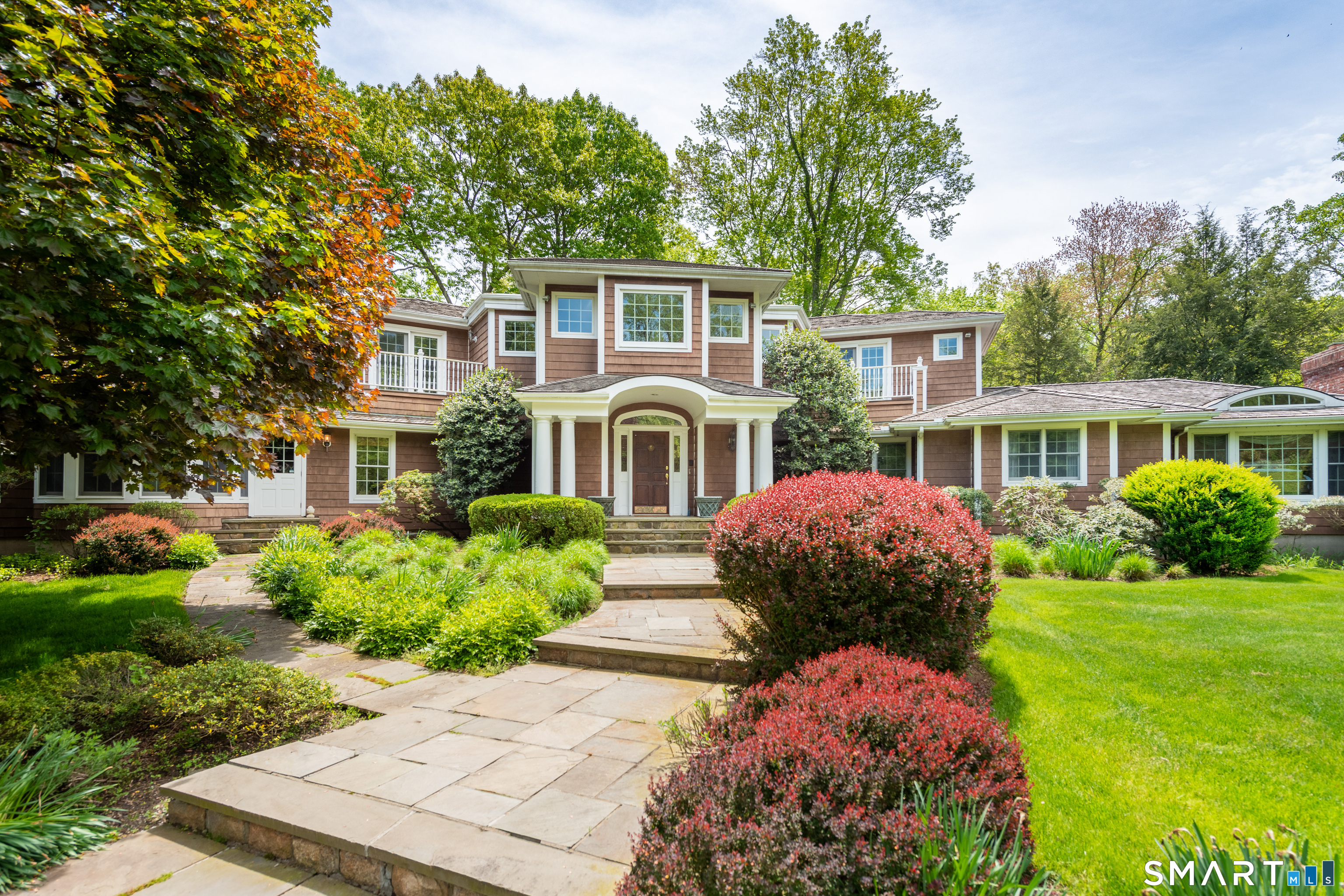 41 Lake Wind Road New Canaan, CT 06840 - Photo 2 of 38 a front view of a house with garden