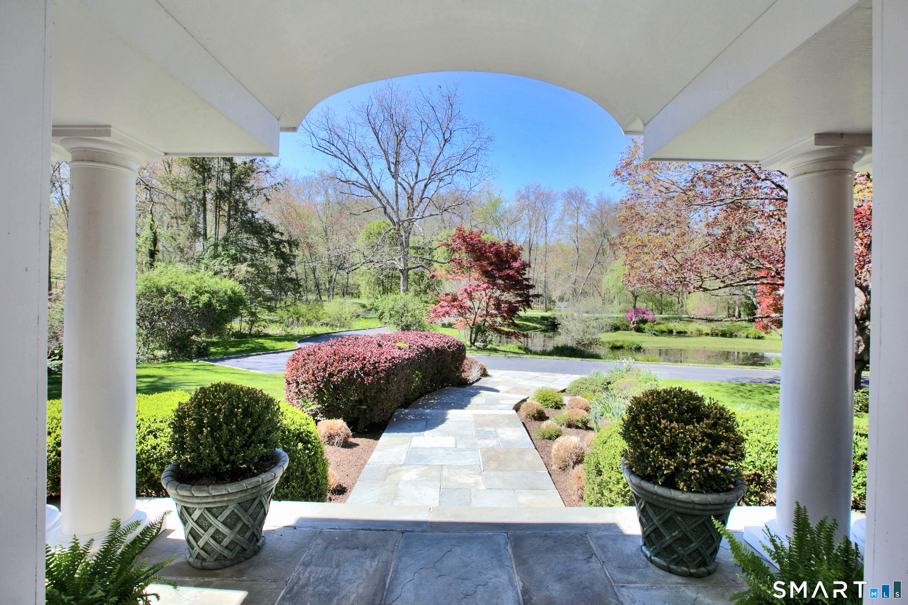 41 Lake Wind Road New Canaan, CT 06840 - Photo 28 of 38 a view of a garden with potted plants