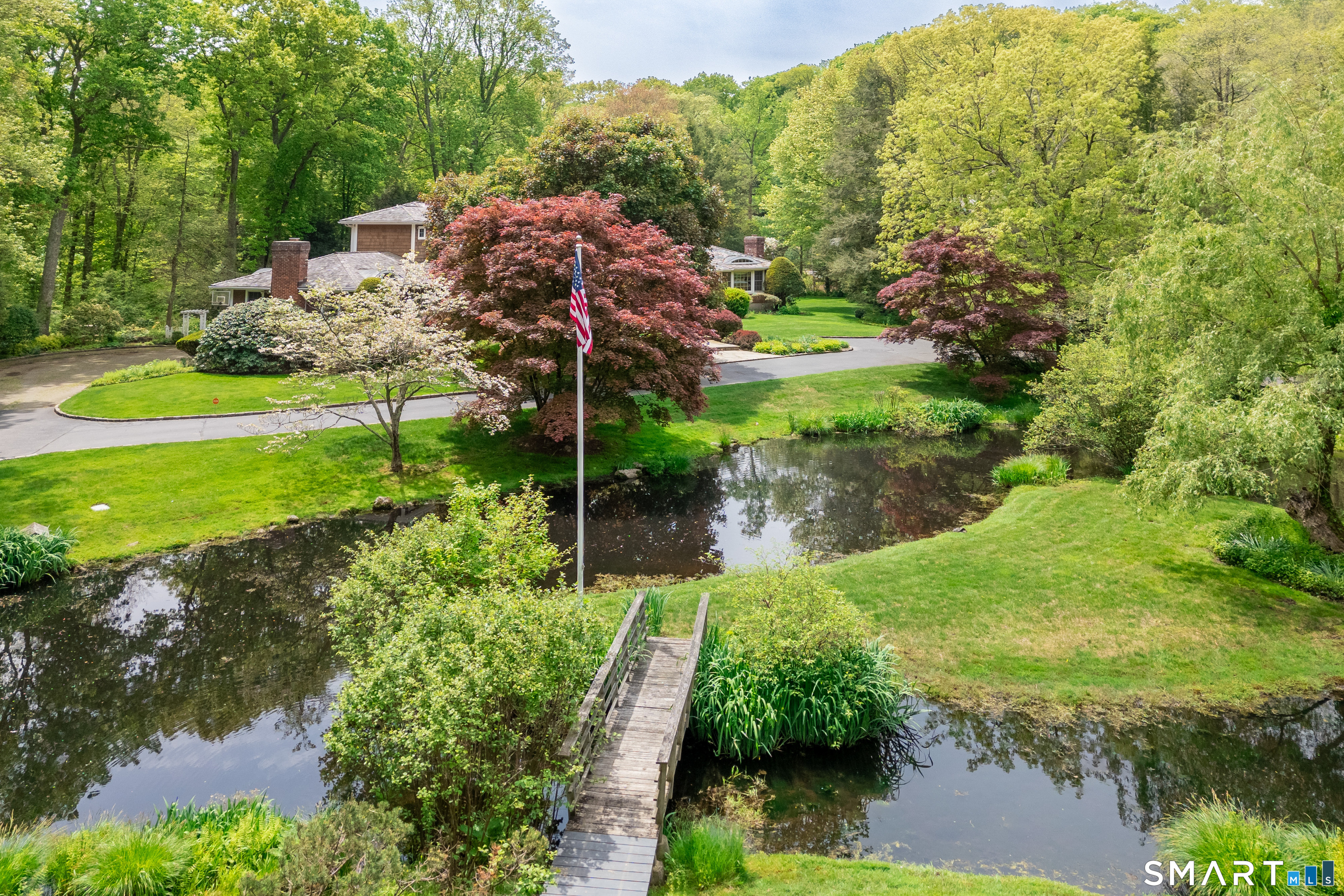 41 Lake Wind Road New Canaan, CT 06840 - Photo 29 of 38 a view of a garden with an outdoor space