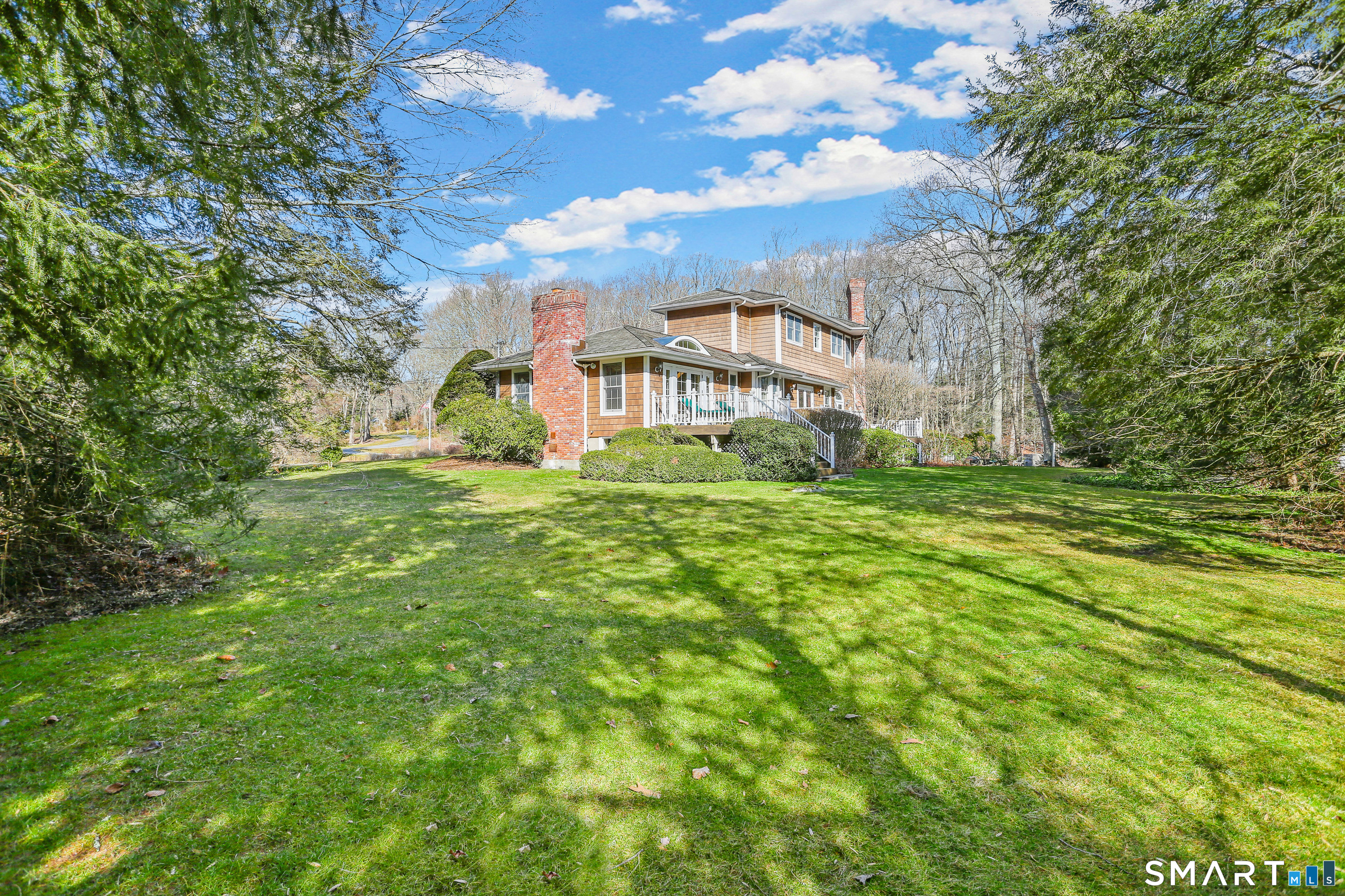 41 Lake Wind Road New Canaan, CT 06840 - Photo 32 of 38 a view of a house with a big yard and large trees