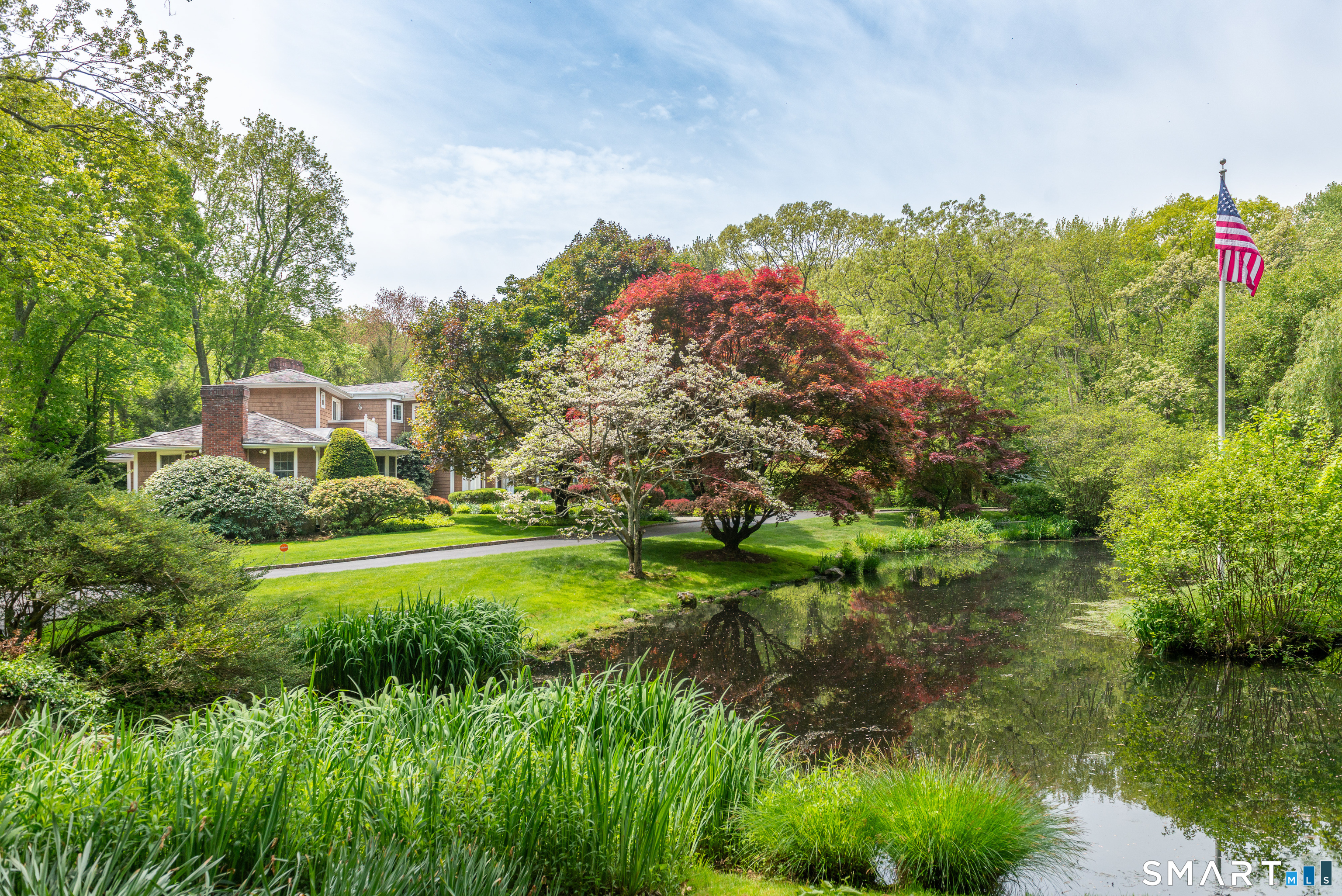 41 Lake Wind Road New Canaan, CT 06840 - Photo 34 of 38 a view of a garden with a lake
