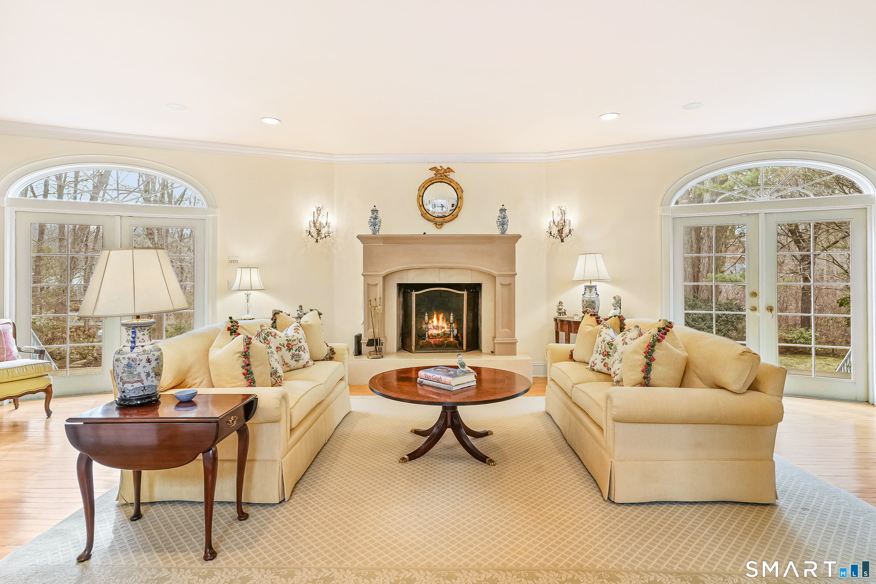 41 Lake Wind Road New Canaan, CT 06840 - Photo 5 of 38 a living room with furniture a fireplace and a table