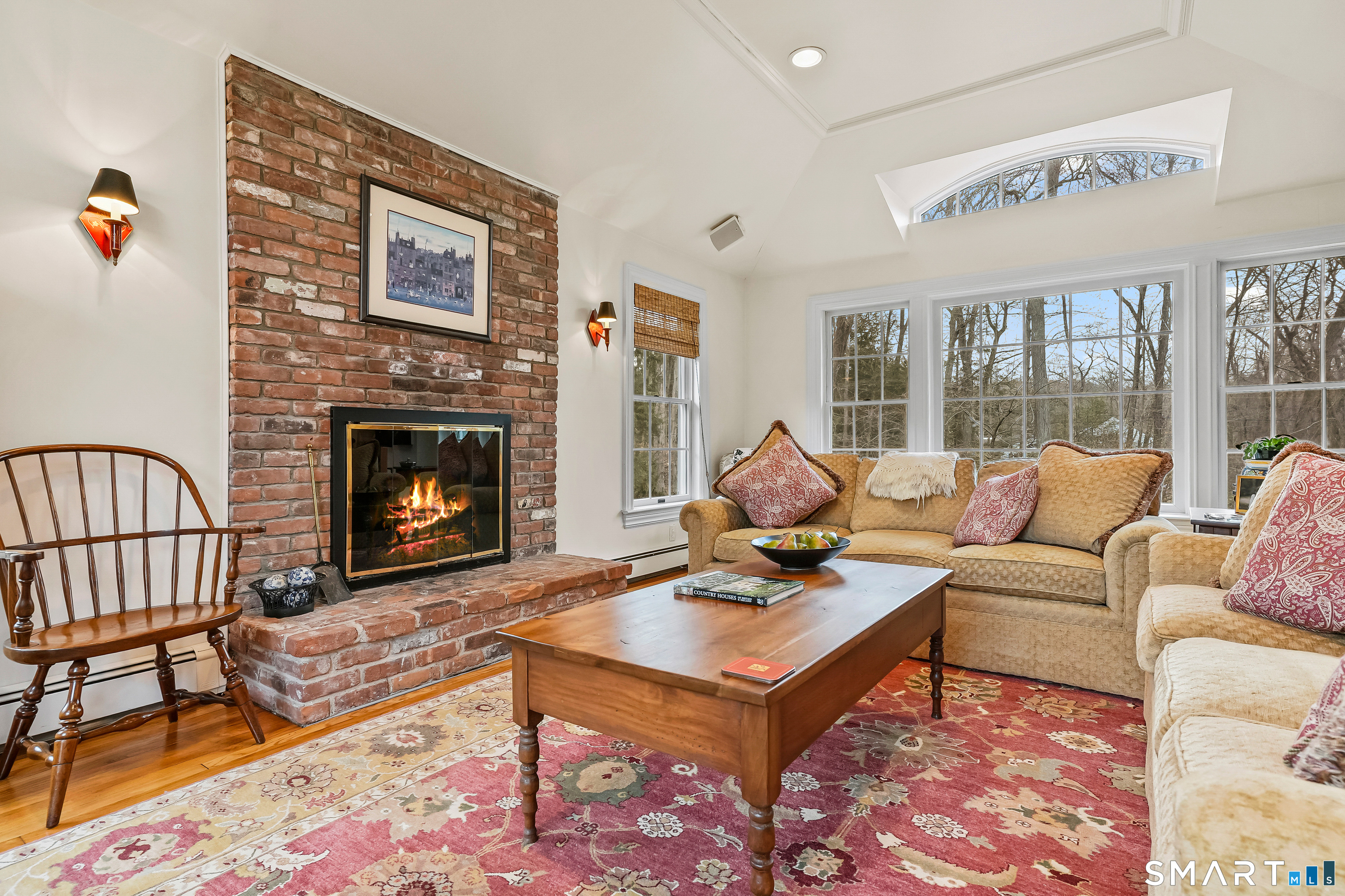 41 Lake Wind Road New Canaan, CT 06840 - Photo 10 of 38 a living room with furniture a rug and a fireplace