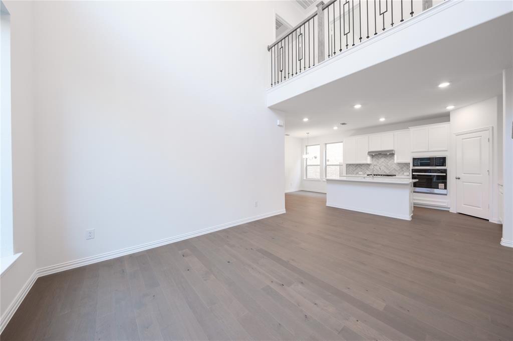1413 Sun Gdn Way Justin, TX 76247 - Photo 13 of 36 a view of kitchen with kitchen island wooden floor and refrigerator
