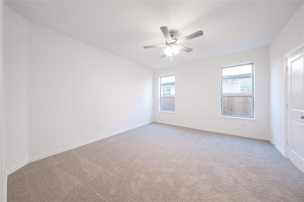 1413 Sun Gdn Way Justin, TX 76247 - Photo 14 of 36 an empty room with windows and fan