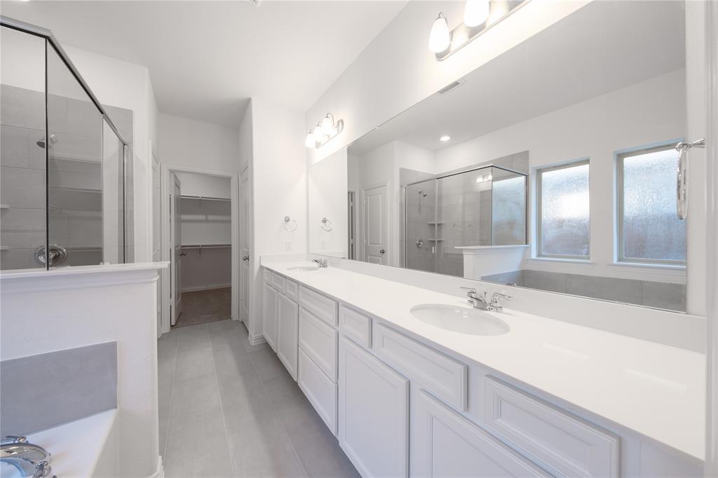 1413 Sun Gdn Way Justin, TX 76247 - Photo 17 of 36 a large white bathroom with a double vanity sink mirror and a bathtub