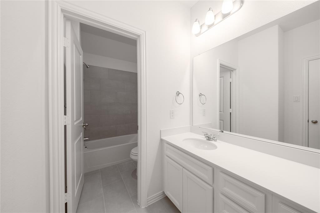 1413 Sun Gdn Way Justin, TX 76247 - Photo 26 of 36 a bathroom with a sink and a mirror