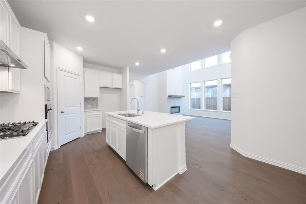 1413 Sun Gdn Way Justin, TX 76247 - Photo 5 of 36 a kitchen with a sink stove and refrigerator