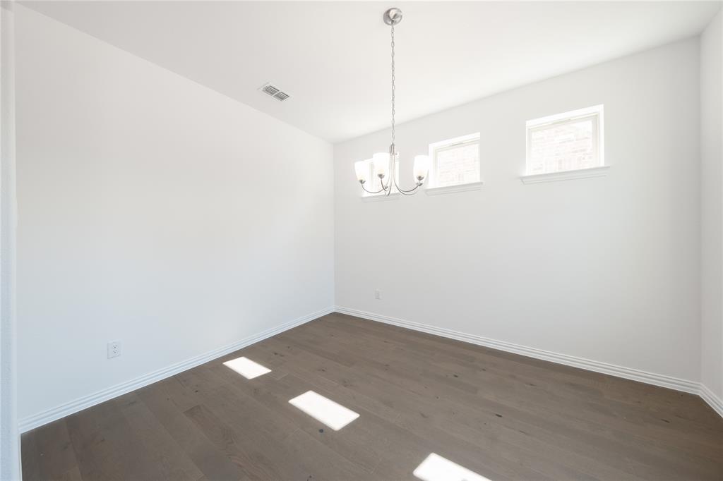1413 Sun Gdn Way Justin, TX 76247 - Photo 8 of 36 a view of a room with a ceiling fan and wooden floor
