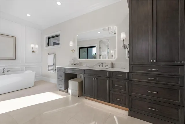 a spacious bathroom with a tub double sink and mirror