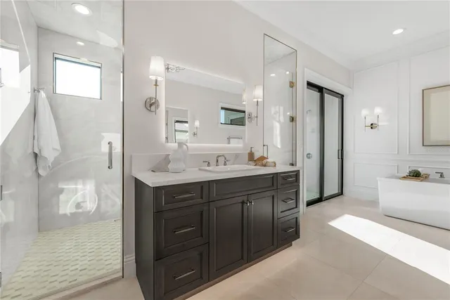 a spacious bathroom with a shower sink and mirror