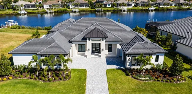 a view of a house with pool and chairs