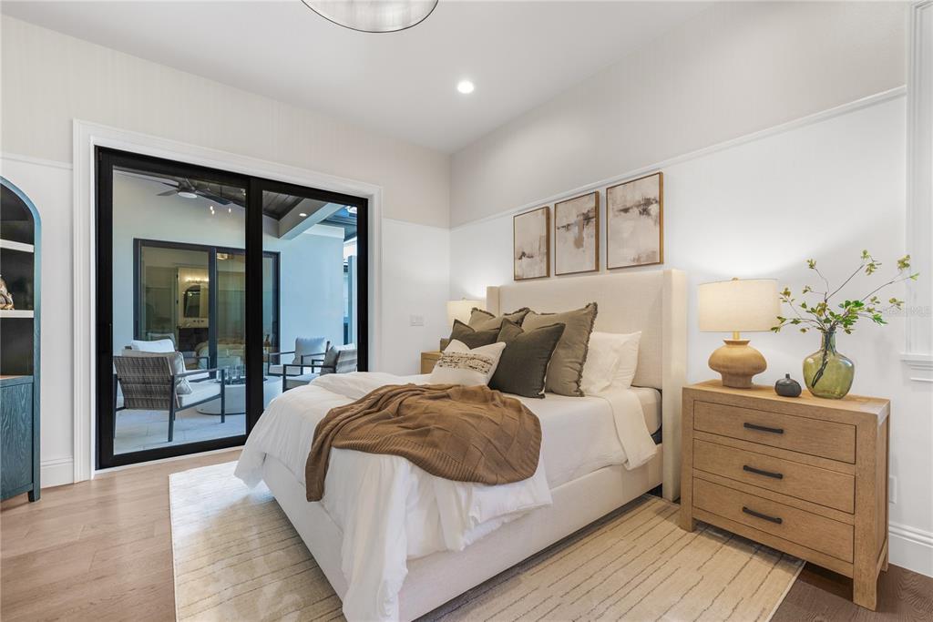 1621 Rio Vista Terrace Parrish, FL 34219 - Photo 23 of 27 a large bedroom with a bed and wooden floor