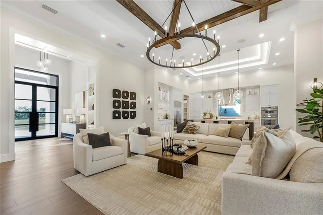 a living room with furniture a clock and a ceiling fan