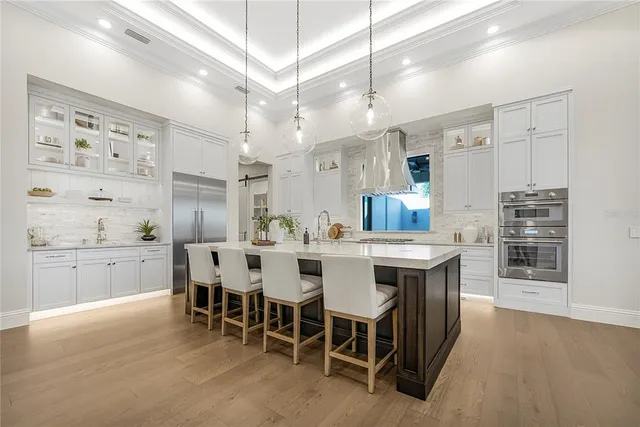 a large kitchen with a table and chairs