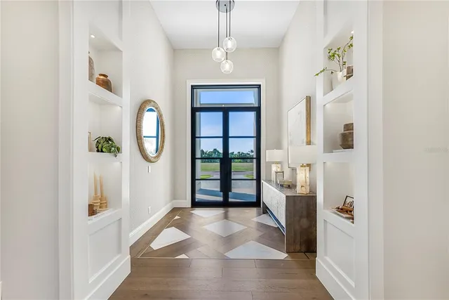 a view of a hallway with windows and entryway