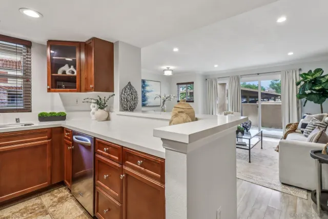 a kitchen with kitchen island granite countertop a sink and chairs