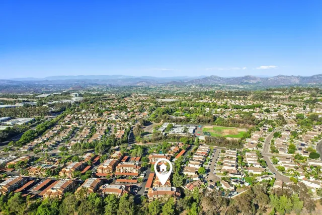 a view of a house with backyard patio and swimming pool