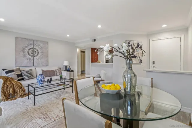 a living room with furniture and kitchen view