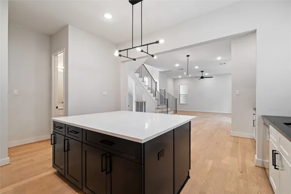 a kitchen that has a sink a stove and a wooden floor