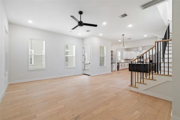 a view of an empty room with a kitchen