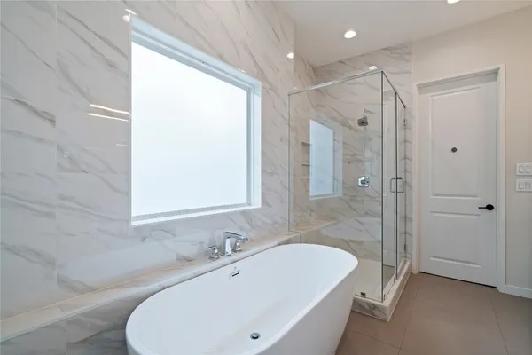 a white bath tub sitting next to a white sink