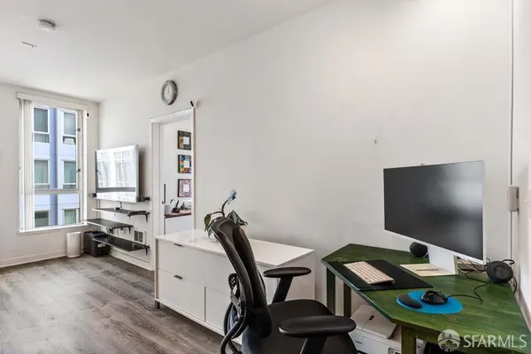 a view of a workspace with furniture and a flat screen tv