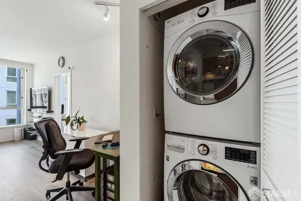 a view of a bedroom with washer and dryer