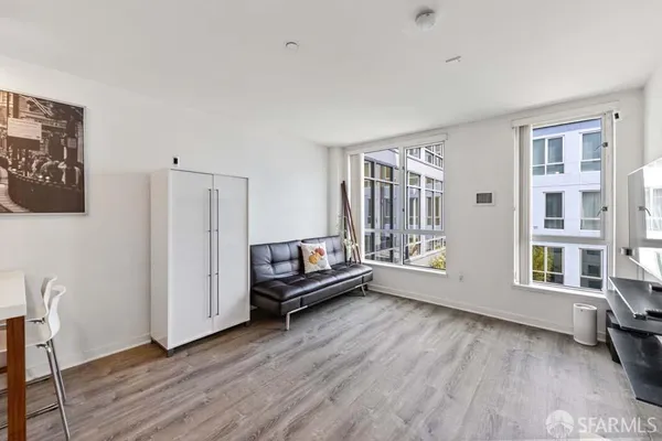 a view of workspace with wooden floor and windows