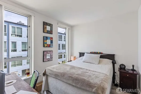 a bedroom with a bed and a television