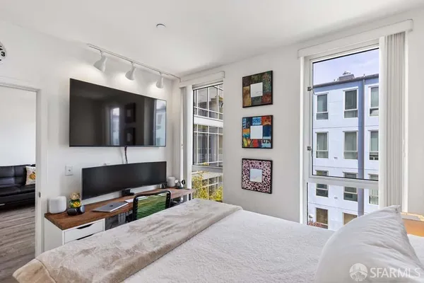 a bedroom with a bed a bookshelf a desk and chair