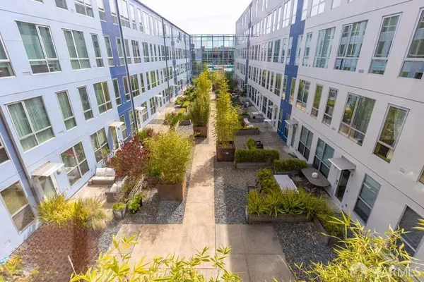 a view of a pathway with a garden