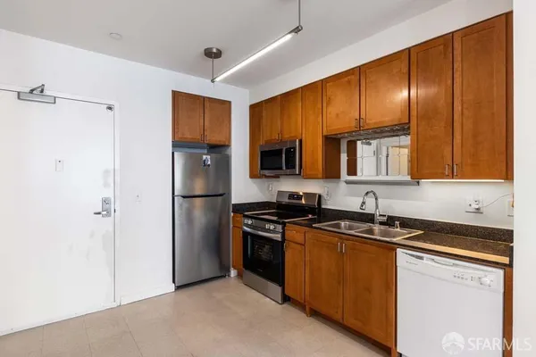 a kitchen with stainless steel appliances granite countertop a refrigerator and a sink