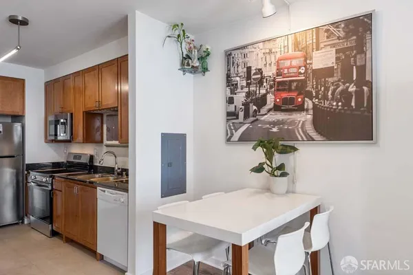 a kitchen with stainless steel appliances a sink stove and refrigerator
