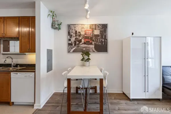 a kitchen with stainless steel appliances granite countertop a refrigerator and a stove top oven