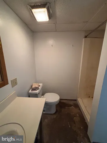 a view of a patio with a table and chairs under an umbrella