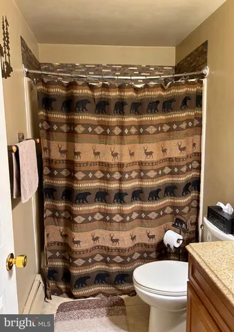 a bathroom with a toilet and a shower