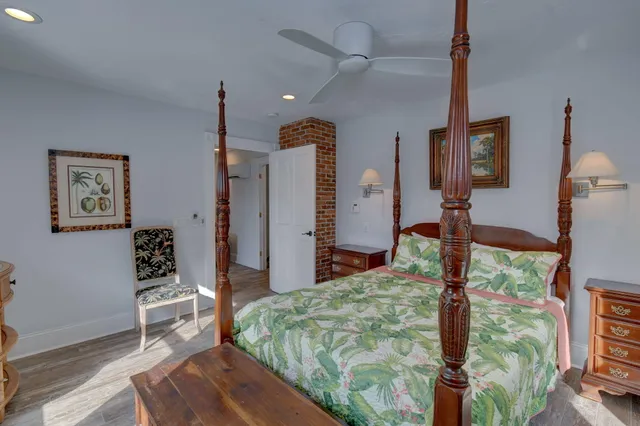 a bedroom with a bed dresser and a large mirror