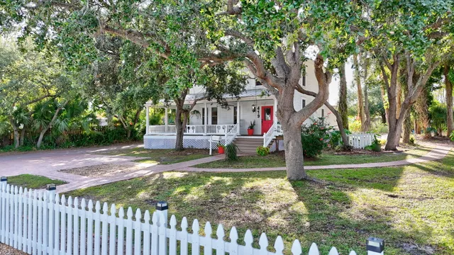 a view of a house with backyard and tree s