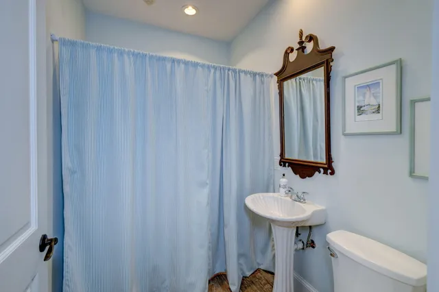 a bathroom with a sink a mirror and a toilet