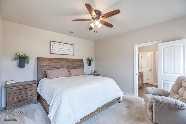 a bedroom with a bed and ceiling fan