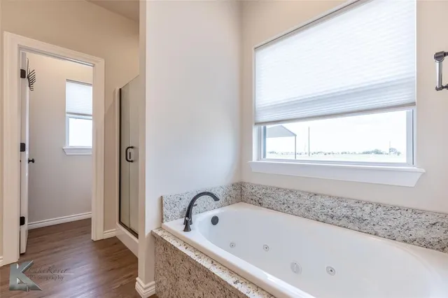 a bath tub sitting next to a window
