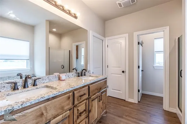 a bathroom with a granite countertop sink mirror and double