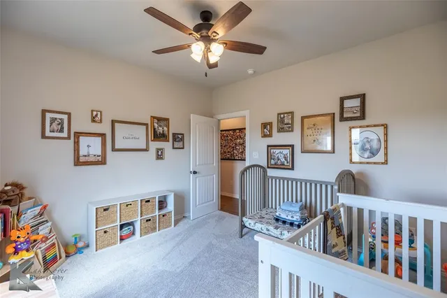 a bedroom with furniture a baby crib and a wooden floor