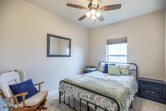 a bedroom with a bed and a chair