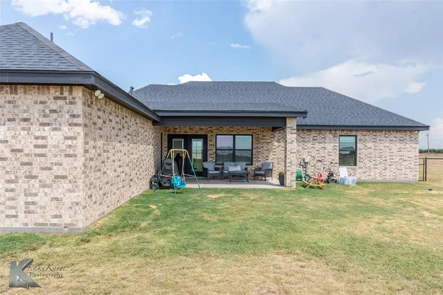 a view of a livingroom with window and swimming pool