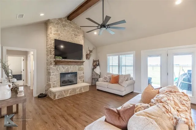 a living room with furniture a fireplace and a flat screen tv