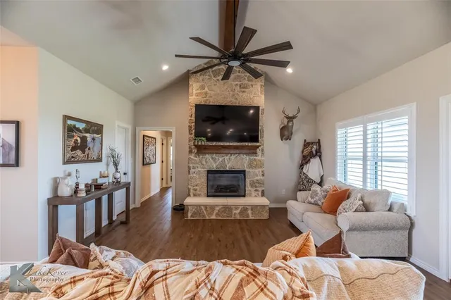 a living room with furniture a window and a fireplace