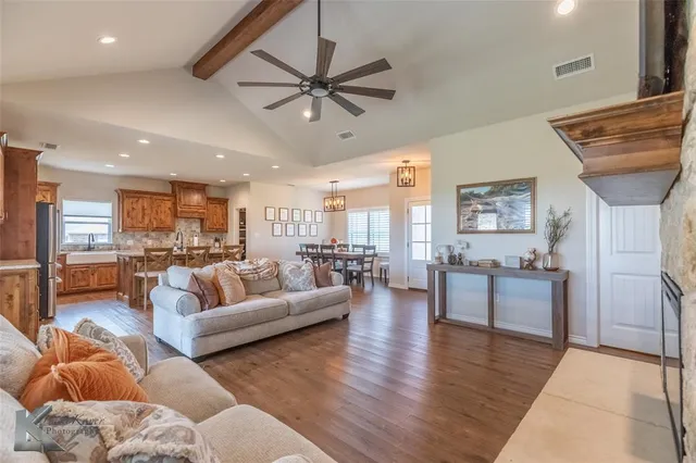 a living room with furniture and kitchen view